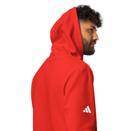 A man wearing a red jacket with a white logo on the chest.